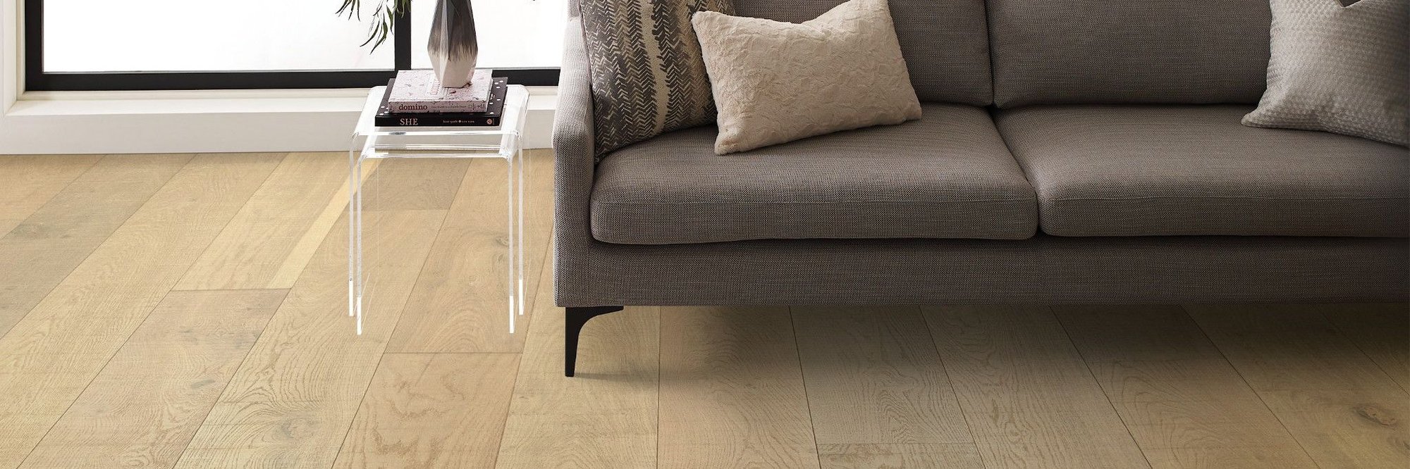 brown couch on light brown hardwood floor from The Carpet and Drapery Shoppe in Escanaba, MI