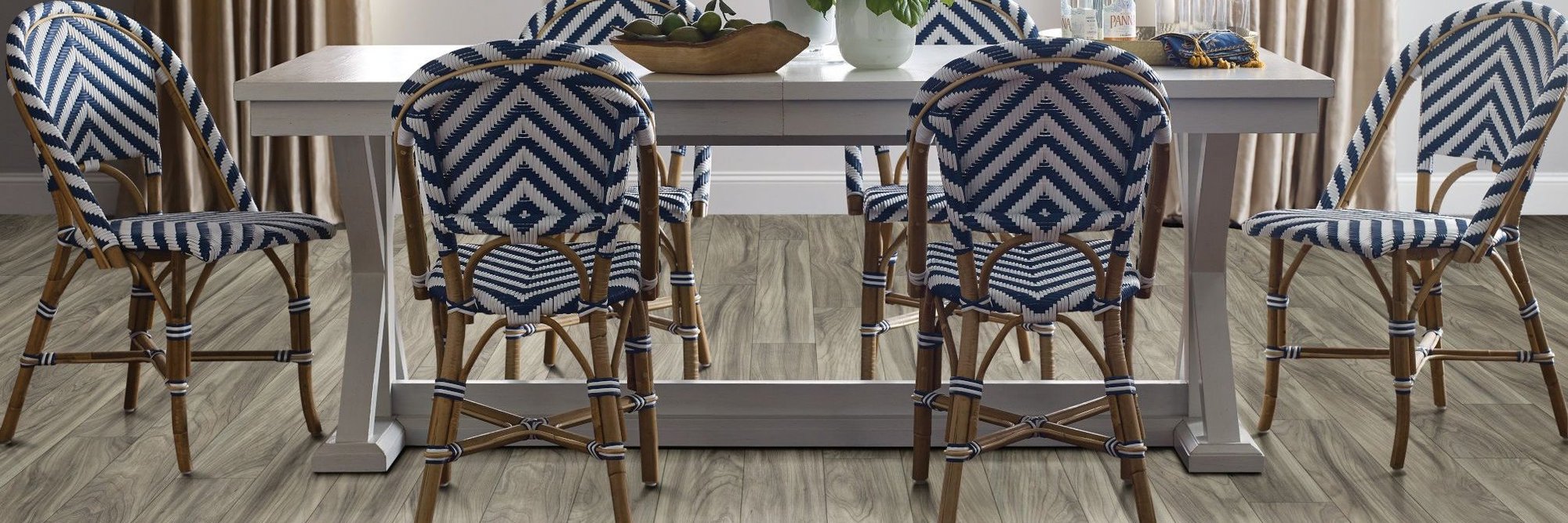 dining table and chairs on brown laminate floor from The Carpet and Drapery Shoppe in Escanaba, MI